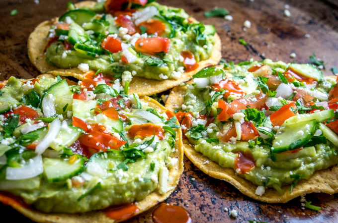 These Vegan Avocado Hummus and Cucumber Pico de Gallo Tostadas will make even the crankiest of carnivores take a second bite. Final zip from some hot sauce highly recommended. So good! mexicanplease.com