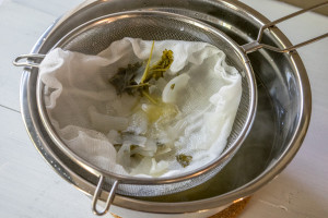 straining vegetable stock with cheesecloth