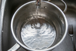 adding water to pot for homemade lard