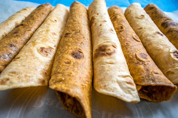 Two versions of homemade chipotle infused flour tortillas; one using chipotles in adobo, the other using chipotle powder. Both taste great and once you get the basic technique down the flavor variations are endless. mexicanplease.com