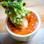 baked taquitos dipped in tomato chipotle salsa