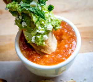 baked taquitos dipped in tomato chipotle salsa