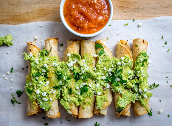 baked taquitos with tomato chipotle salsa overhead