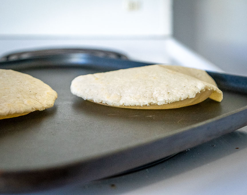 Use a spatula to make your corn tortillas puff up