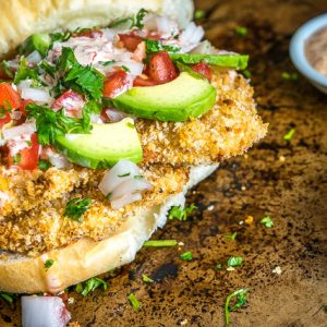 This Baked Milanesa Torta is loaded with avocado, Pico de Gallo and chipotle mayo. Yowsa! No frying either, just bread the chicken cutlets and give 'em 12 minutes in the oven. Buen Provecho. mexicanplease.com