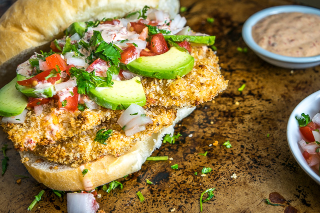 This Baked Milanesa Torta is loaded with avocado, Pico de Gallo and chipotle mayo. Yowsa! No frying either, just bread the chicken cutlets and give 'em 12 minutes in the oven. Buen Provecho. mexicanplease.com