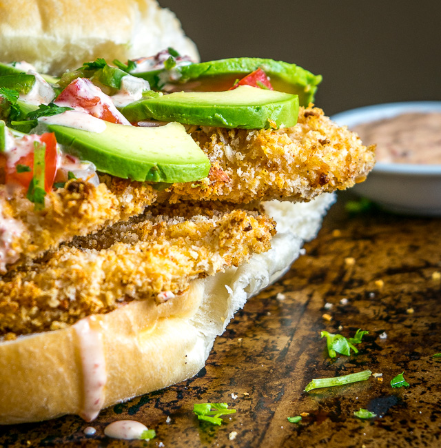 This Baked Milanesa Torta is loaded with avocado, Pico de Gallo and chipotle mayo. Yowsa! No frying either, just bread the chicken cutlets and give 'em 12 minutes in the oven. Buen Provecho. mexicanplease.com