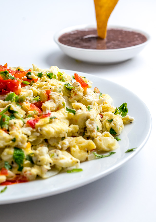 These Mexican Scrambled Eggs are perfect for lazy weekend mornings: well-balanced, easy to make, and they have real kick. Try draining the tomatoes before adding them to the pan, so much better! mexicanplease.com