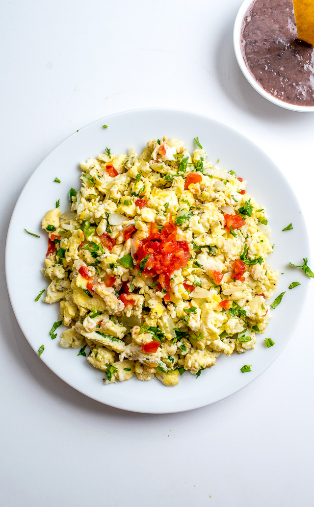 These Mexican Scrambled Eggs are perfect for lazy weekend mornings: well-balanced, easy to make, and they have real kick. Try draining the tomatoes before adding them to the pan, so much better! mexicanplease.com