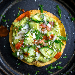 These Vegan Avocado Hummus and Cucumber Pico de Gallo Tostadas will make even the crankiest of carnivores take a second bite. Final zip from some hot sauce highly recommended. So good! mexicanplease.com