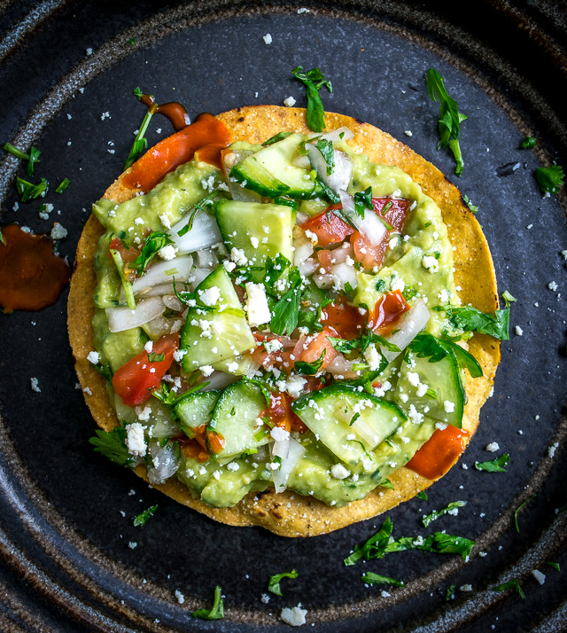 These Vegan Avocado Hummus and Cucumber Pico de Gallo Tostadas will make even the crankiest of carnivores take a second bite. Final zip from some hot sauce highly recommended. So good! mexicanplease.com