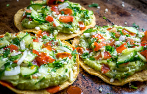 These Vegan Avocado Hummus and Cucumber Pico de Gallo Tostadas will make even the crankiest of carnivores take a second bite. Final zip from some hot sauce highly recommended. So good! mexicanplease.com