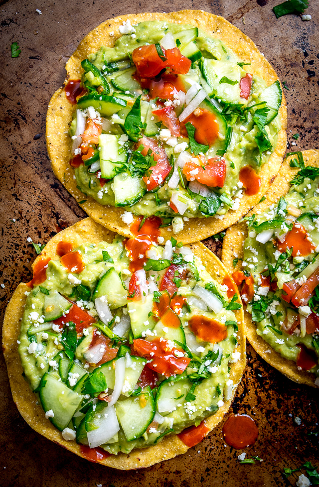 These Vegan Avocado Hummus and Cucumber Pico de Gallo Tostadas will make even the crankiest of carnivores take a second bite. Final zip from some hot sauce highly recommended. So good! mexicanplease.com