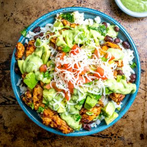 These Easy Burrito Bowls have a secret weapon that can instantly save your day: creamy avocado sauce with some zip from a jalapeno. So good! mexicanplease.com