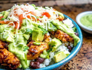 These Easy Burrito Bowls have a secret weapon that can instantly save your day: creamy avocado sauce with some zip from a jalapeno. So good! mexicanplease.com