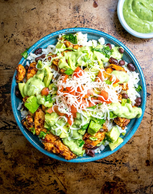 These Easy Burrito Bowls have a secret weapon that can instantly save your day: creamy avocado sauce with some zip from a jalapeno. So good! mexicanplease.com
