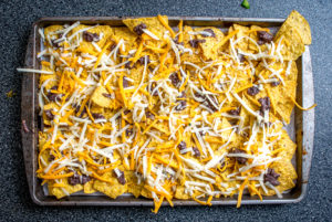 It's tough to beat the combo of warm tortilla chips, melted cheese, and spicy black beans. In other words, NACHOS!! These beans have some kick built into them from chipotles in adobo and they are beyond delicious. mexicanplease.com