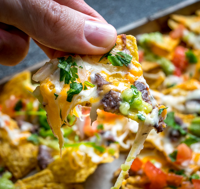 It's tough to beat the combo of warm tortilla chips, melted cheese, and spicy black beans. In other words, NACHOS!! These beans have some kick built into them from chipotles in adobo and they are beyond delicious. mexicanplease.com