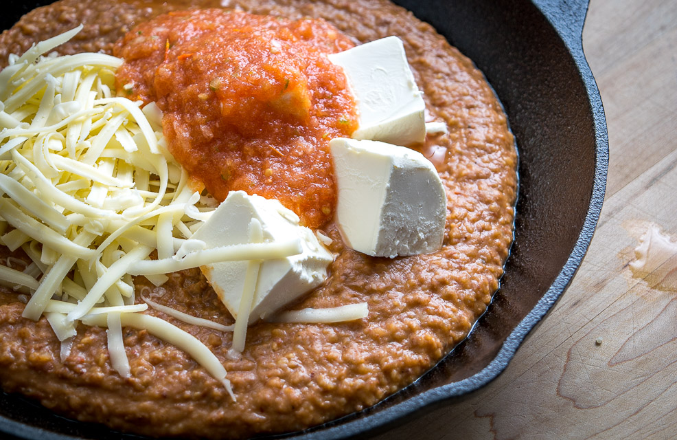 Sure, this Cheesy Bean Dip works great for office parties and family get-togethers, but it tastes better when you make it for yourself :) Chipotles in adobo give the pinto bean puree incredible flavor. So good! mexicanplease.com