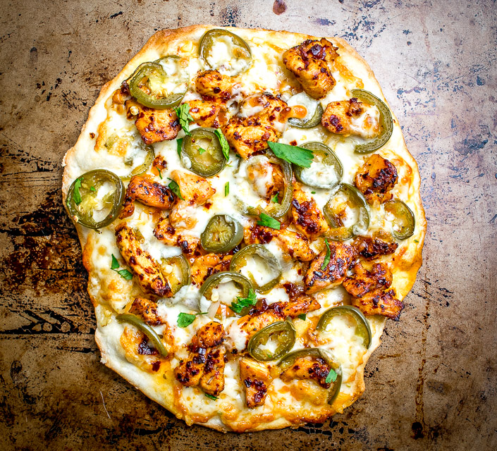 This Spicy Chicken and Pickled Jalapeno Pizza is the perfect example of Mexican cooking ingredients influencing just about everything in my kitchen. A super easy and delicious recipe with no special pizza gear needed! mexicanplease.com