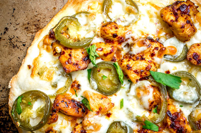 This Spicy Chicken and Pickled Jalapeno Pizza is the perfect example of Mexican cooking ingredients influencing just about everything in my kitchen. A super easy and delicious recipe with no special pizza gear needed! mexicanplease.com