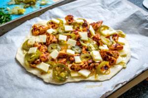 This Spicy Chicken and Pickled Jalapeno Pizza is the perfect example of Mexican cooking ingredients influencing just about everything in my kitchen. A super easy and delicious recipe with no special pizza gear needed! mexicanplease.com