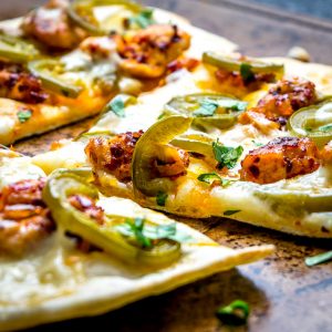 This Spicy Chicken and Pickled Jalapeno Pizza is the perfect example of Mexican cooking ingredients influencing just about everything in my kitchen. A super easy and delicious recipe with no special pizza gear needed! mexicanplease.com