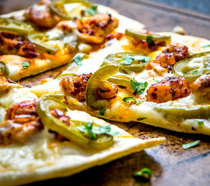 This Spicy Chicken and Pickled Jalapeno Pizza is the perfect example of Mexican cooking ingredients influencing just about everything in my kitchen. A super easy and delicious recipe with no special pizza gear needed! mexicanplease.com