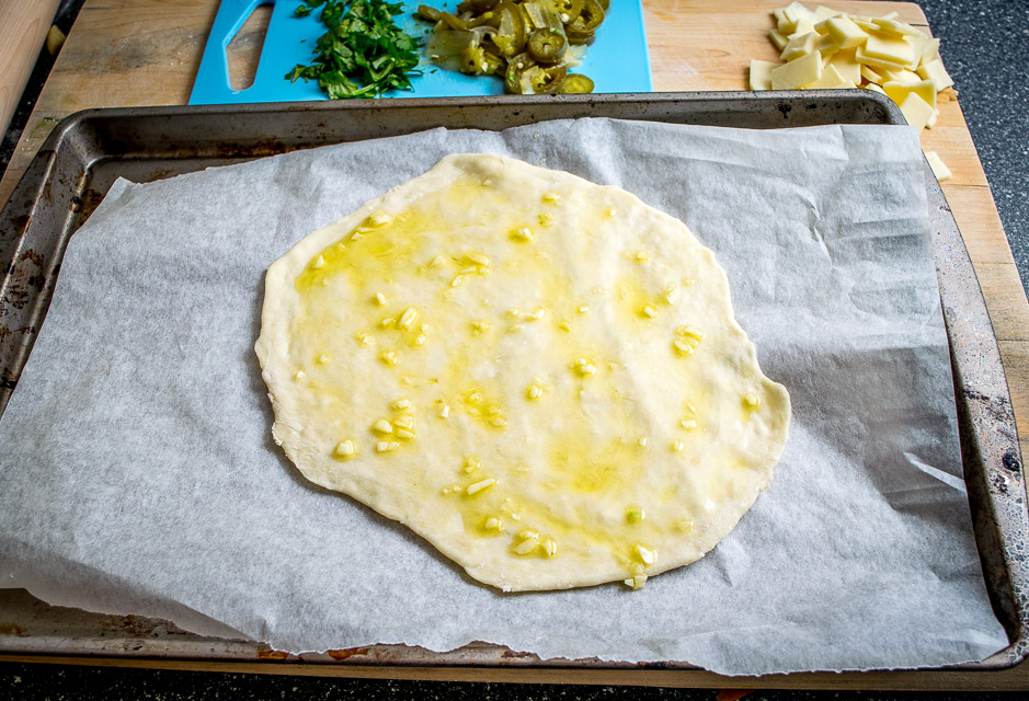 This Spicy Chicken and Pickled Jalapeno Pizza is the perfect example of Mexican cooking ingredients influencing just about everything in my kitchen. A super easy and delicious recipe with no special pizza gear needed! mexicanplease.com