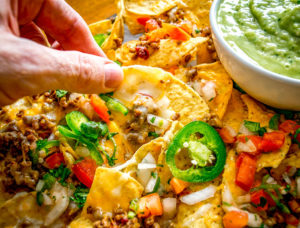These Spicy Ground Beef Nachos have the potential to save your day. Chipotles in adobo give the beef real kick and when loaded on cheese covered tortilla chips they quickly become a go-to meal. Served with a homemade Avocado Salsa Verde and your choice of fixings. So good! mexicanplease.com
