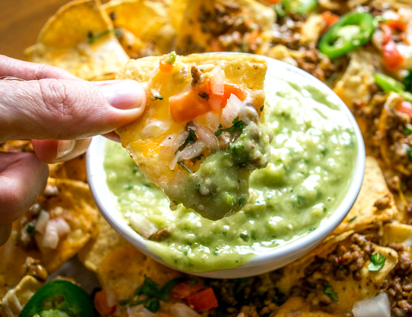 These Spicy Ground Beef Nachos have the potential to save your day. Chipotles w adobo dają wołowinie prawdziwego kopa, a kiedy są nadziewane na chipsy tortilla pokryte serem, szybko stają się posiłkiem typu go-to. Podawane z domową Salsą Verde z awokado i dodatkami do wyboru. So good! mexicanplease.com