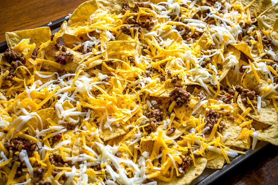 These Spicy Ground Beef Nachos have the potential to save your day. Chipotles in adobo give the beef real kick and when loaded on cheese covered tortilla chips they quickly become a go-to meal. Served with a homemade Avocado Salsa Verde and your choice of fixings. So good! mexicanplease.com