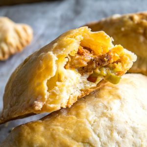 Here's a great combo to consider for your next batch of homemade empanadas: spicy chicken and pickled jalapenos. Don't forget to chill the dough before rolling it out as this will keep them light and flaky. So good! mexicanplease.com
