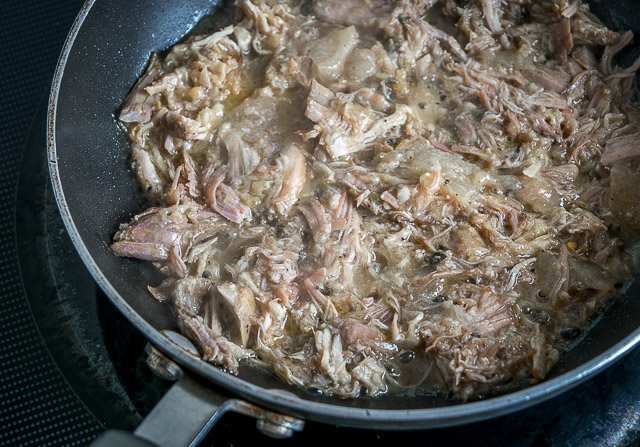 warming up carnitas for mexican cuban sandwich