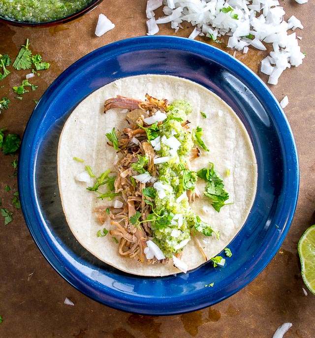 One of my all-time favorite recipes! The slow cooker keeps these carnitas moist and loads them up with flavor. Best combo for tacos is carnitas, salsa verde, onion, cilantro and a squeeze of lime. So good! mexicanplease.com