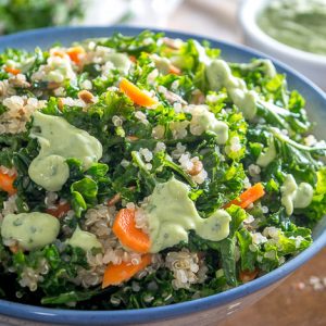 A light, zippy Kale and Quinoa Salad drenched in a yogurt based Creamy Avocado Dressing. As healthy as it gets with loads of flavor. So good! mexicanplease.com