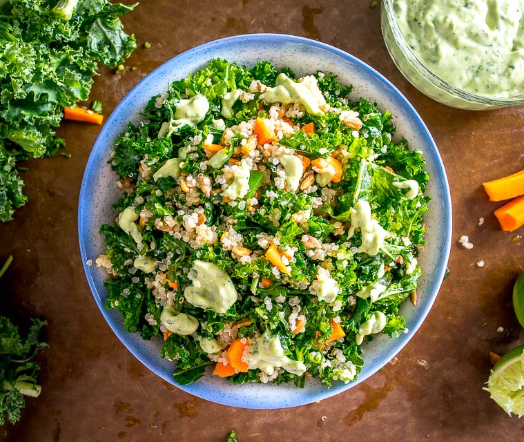 A light, zippy Kale and Quinoa Salad drenched in a yogurt based Creamy Avocado Dressing. As healthy as it gets and loaded with flavor. So good! mexicanplease.com