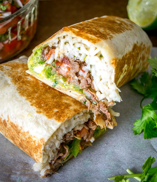 Freshly made Pico de Gallo combines with Barbacoa Beef and Guacamole to make these Barbacoa Beef Burritos sing! Slow cooker barbacoa works great but feel free to use any shredded beef you have on hand. So good! mexicanplease.com
