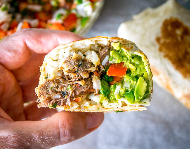 Freshly made Pico de Gallo combines with Barbacoa Beef and Guacamole to make these Barbacoa Beef Burritos sing! Slow cooker barbacoa works great but feel free to use any shredded beef you have on hand. So good! mexicanplease.com