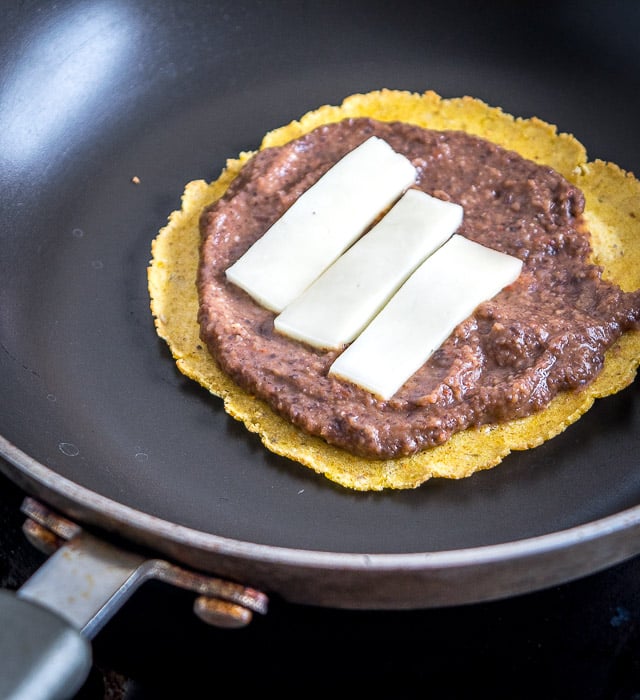 Serious reward to effort ratio here! We're crisping a corn tortilla and loading it up with spicy black bean puree and a refreshing guacamole. So good! mexicanplease.com