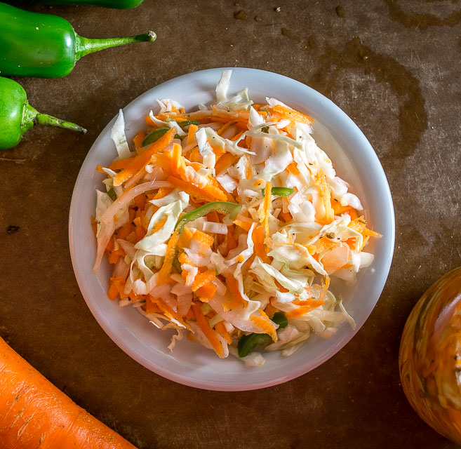 Curtido is a lightly fermented cabbage slaw common in Central America. Using a jalapeno gives it some real zip but you can always dial back on it if you want. mexicanplease.com