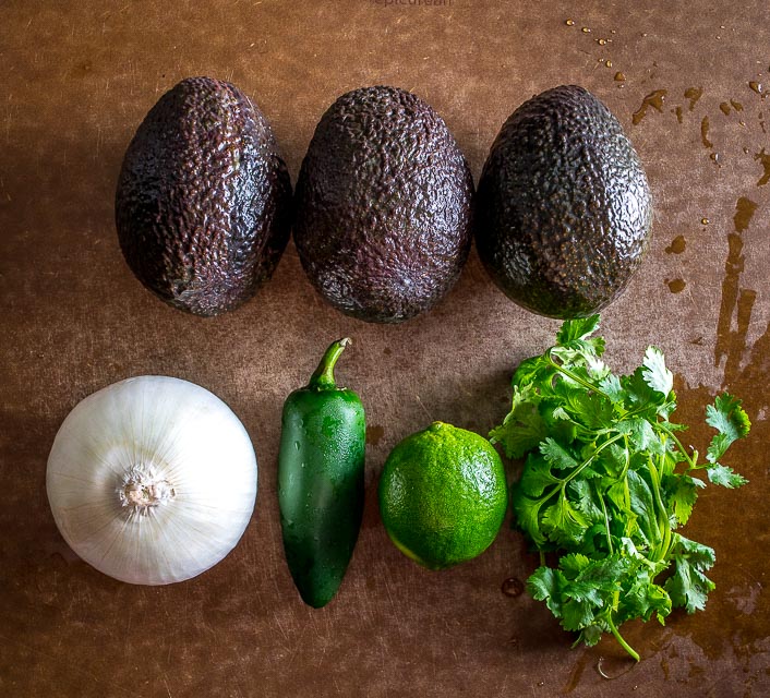 We're grinding an onion-jalapeno-cilantro paste in a molcajete for a delicious batch of homemade guacamole. Don't forget a final squeeze of lime, so good! mexicanplease.com