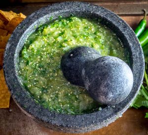 The flavor you can generate by smooshing ingredients in a molcajete is unreal. You'll end up with a vibrant batch of Salsa Verde that could potentially cause you to break up with the other salsas in your life. mexicanplease.com