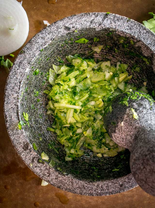 The flavor you can generate by smooshing ingredients in a molcajete is unreal. You'll end up with a vibrant batch of Salsa Verde that could potentially cause you to break up with the other salsas in your life. mexicanplease.com 