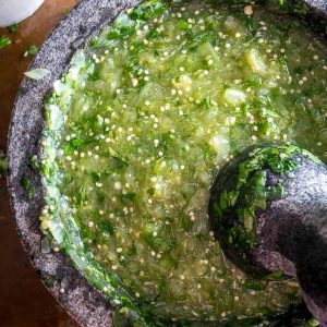 The flavor you can generate by smooshing ingredients in a molcajete is unreal. You'll end up with a vibrant batch of Salsa Verde that could potentially cause you to break up with the other salsas in your life. mexicanplease.com