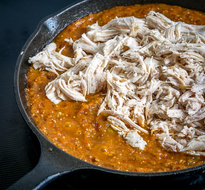 This is a delicious, fiery version of Chicken Tinga. The key is to use both tomatoes and tomatillos, along with plenty of chipotles! mexicanplease.com