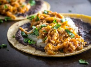 This is a delicious, fiery version of Chicken Tinga. The key is to use both tomatoes and tomatillos, along with plenty of chipotles! mexicanplease.com