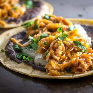 This is a delicious, fiery version of Chicken Tinga. The key is to use both tomatoes and tomatillos, along with plenty of chipotles! mexicanplease.com