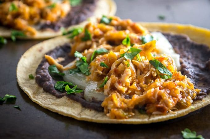 This is a delicious, fiery version of Chicken Tinga. The key is to use both tomatoes and tomatillos, along with plenty of chipotles! mexicanplease.com