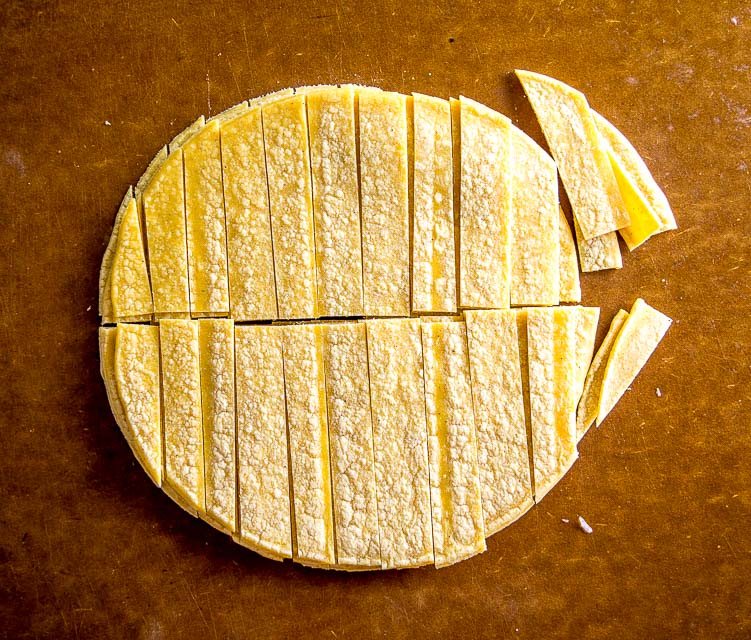 chopping corn tortillas for migas
